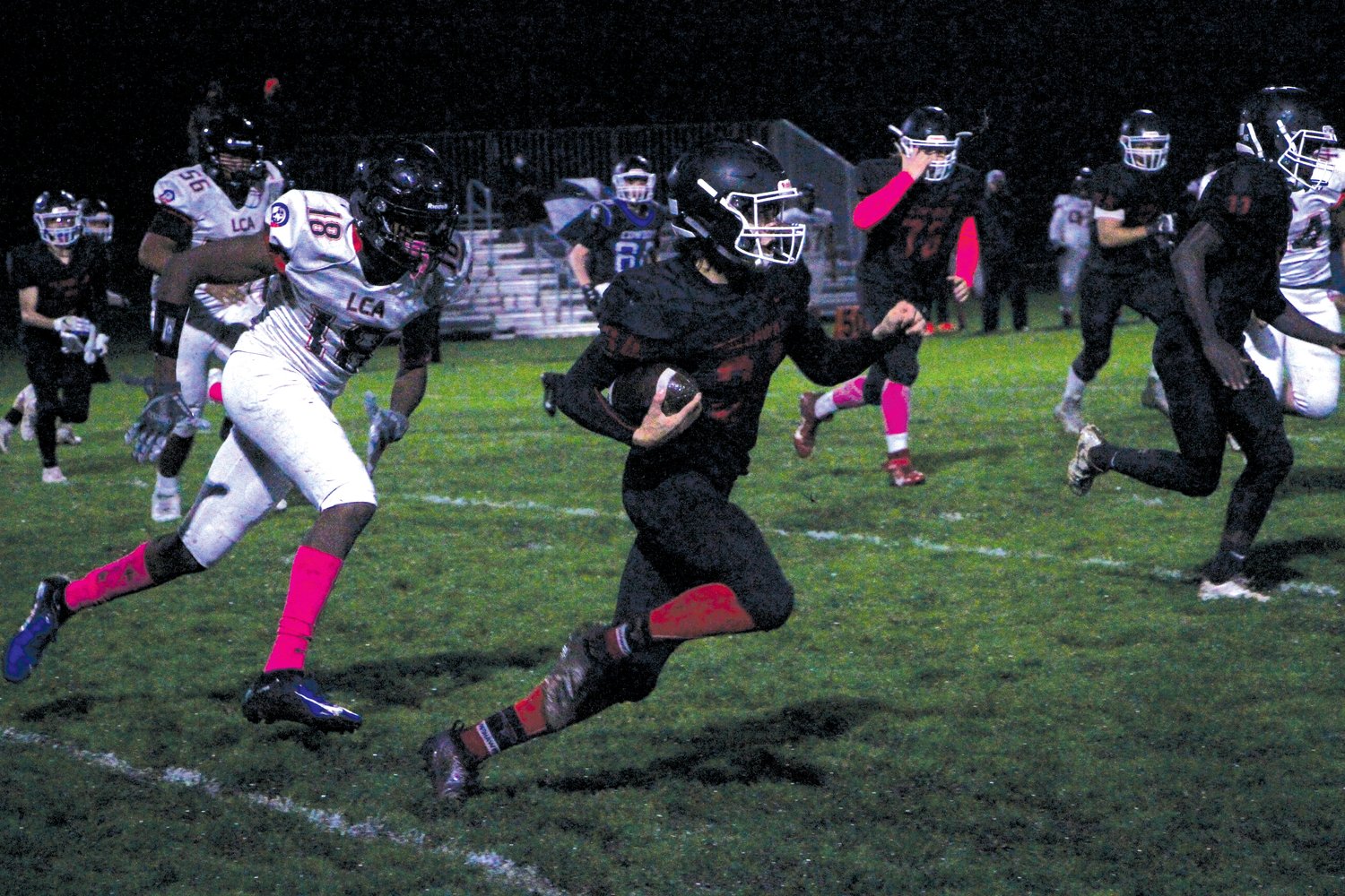 Senior running back Logan Massie charges past Eagles defenders. Massie scored three touchdowns in the first half and had 169 rushing yards at the final whistle.